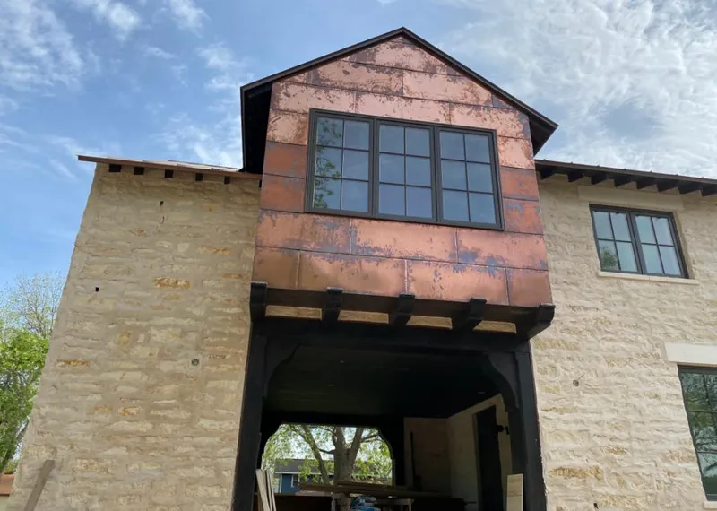 Copper metal panel facade on a stone building for Skylight Installation in Westmoreland