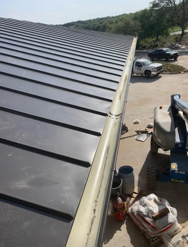 Standing seam panel and gutter detail on a metal roofing jobsite in Westmoreland